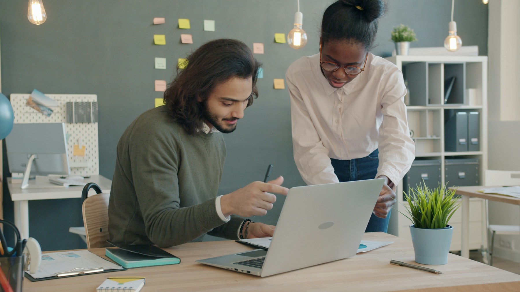 Accounting team collaborating at a laptop in an office